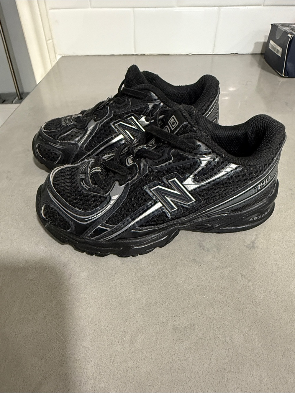 New Balance Kids Black Athletic Sneakers with Reflective Details
